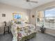 A bright bedroom with large windows, floral bedding, and cozy decor for a relaxing space at 2403 S Atlantic Ave # 410, Daytona Beach, FL 32118