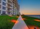 Exterior building with ocean view features pool and walkway at 2403 S Atlantic Ave # 410, Daytona Beach, FL 32118
