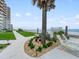 Walkway with beach access, lounge chairs, and ornamental plants at 2403 S Atlantic Ave # 410, Daytona Beach, FL 32118