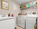 Laundry room features a white washer and dryer set and utility sink at 2403 S Atlantic Ave # 410, Daytona Beach, FL 32118