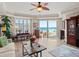 Bright living room with ocean view, featuring a ceiling fan, tile flooring, and sliding doors to the balcony at 2403 S Atlantic Ave # 410, Daytona Beach, FL 32118
