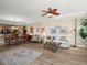 An open-concept living and dining area featuring hardwood floors and a decorative ceiling fan at 2403 S Atlantic Ave # 410, Daytona Beach, FL 32118