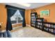 Cozy living room with a window view, bookshelves, and tile flooring at 2403 S Atlantic Ave # 410, Daytona Beach, FL 32118