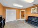 Lobby with white closets, a decorative painting, and a dark-colored sofa at 2403 S Atlantic Ave # 410, Daytona Beach, FL 32118