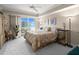 Comfortable main bedroom with a ceiling fan and sliding doors to a balcony at 2403 S Atlantic Ave # 410, Daytona Beach, FL 32118