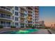 Exterior of condo building with pool and lounge chairs at 2403 S Atlantic Ave # 410, Daytona Beach, FL 32118