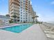 Exterior pool with lounge chairs overlooking the ocean at 2403 S Atlantic Ave # 410, Daytona Beach, FL 32118