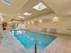 Indoor pool with skylights, benches, and clear blue water at 2403 S Atlantic Ave # 410, Daytona Beach, FL 32118