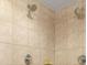Tiled shower featuring dual shower heads and modern fixtures at 2403 S Atlantic Ave # 410, Daytona Beach, FL 32118