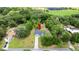 Aerial view of property with red arrow indicating location, surrounded by lush greenery and a beautiful treeline at 2455 Whooping Crane Dr, De Leon Springs, FL 32130
