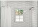 Bathroom shower with honeycomb tile, window view, and shower head at 2455 Whooping Crane Dr, De Leon Springs, FL 32130