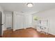 Bedroom with wood floors, dual closets, and functional work space at 2455 Whooping Crane Dr, De Leon Springs, FL 32130