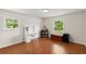 Spacious bedroom with wood floors, natural light, and desk setup at 2455 Whooping Crane Dr, De Leon Springs, FL 32130