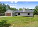 This home features a lush green lawn, a dark roof, and windows at 2455 Whooping Crane Dr, De Leon Springs, FL 32130