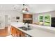 View of the kitchen sink and countertop leading to the dining area with brick fireplace at 2455 Whooping Crane Dr, De Leon Springs, FL 32130