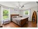 A cozy main bedroom with two windows bringing in plenty of natural light at 2455 Whooping Crane Dr, De Leon Springs, FL 32130