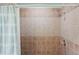 Tiled shower showcasing neutral colors, shower curtain, and shower head at 2455 Whooping Crane Dr, De Leon Springs, FL 32130