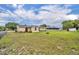 Expansive grassy backyard featuring plenty of room, mature trees, and a charming exterior at 2468 Kimberly Dr, Deltona, FL 32738