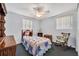 Bright bedroom featuring a cozy bed, rocking chair, and ample natural light at 2468 Kimberly Dr, Deltona, FL 32738