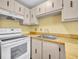 Kitchen with white appliances, wood cabinets, and ample counter space at 2468 Kimberly Dr, Deltona, FL 32738
