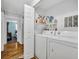 Well-lit laundry area featuring modern washer and dryer units at 2468 Kimberly Dr, Deltona, FL 32738