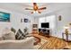 Inviting living room featuring hardwood floors, comfortable seating, and natural light at 2468 Kimberly Dr, Deltona, FL 32738