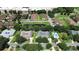 Community aerial view featuring ponds, lush trees, manicured lawns, mature trees, pool and gazebo at 2480 S Glen Eagles Dr, Deland, FL 32724