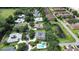 Attractive community aerial view with a pond, lush trees, landscaping, a pool, and beautiful homes at 2480 S Glen Eagles Dr, Deland, FL 32724