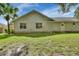 Back of home featuring windows, door to yard, and large grassy area at 2480 S Glen Eagles Dr, Deland, FL 32724