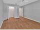 Bedroom featuring hardwood floors, light grey walls, and closet for ample storage at 2480 S Glen Eagles Dr, Deland, FL 32724
