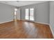 Bright bedroom with wood-look floors and direct access to the backyard at 2480 S Glen Eagles Dr, Deland, FL 32724