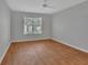 Bedroom featuring wood floors, a window for natural light, and a ceiling fan at 2480 S Glen Eagles Dr, Deland, FL 32724