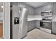Modern kitchen featuring stainless steel appliances, gray cabinetry and stone countertops at 2480 S Glen Eagles Dr, Deland, FL 32724