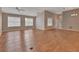 Open concept living room featuring hardwood floors, neutral walls and plenty of natural light at 2480 S Glen Eagles Dr, Deland, FL 32724