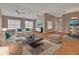 Inviting living room with ceiling fans, hardwood floors, lots of windows and a decorative rug at 2480 S Glen Eagles Dr, Deland, FL 32724