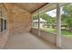 Screened patio with brick accent wall and view of backyard at 2480 S Glen Eagles Dr, Deland, FL 32724