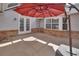 Outdoor patio with painted cement flooring, red umbrella, and brick accents at 2480 S Glen Eagles Dr, Deland, FL 32724