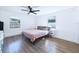 Bright bedroom with wood-look floors, ceiling fan, and a calming color palette at 2526 Victory Palm Dr, Edgewater, FL 32141