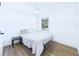 Clean and simple bedroom featuring wood-look floors and neutral decor at 2526 Victory Palm Dr, Edgewater, FL 32141