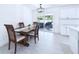 Bright dining room featuring a modern light fixture and sliding glass doors to the outside at 2526 Victory Palm Dr, Edgewater, FL 32141