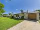 Well-maintained single-story home with attached garage and a neatly kept lawn at 2526 Victory Palm Dr, Edgewater, FL 32141