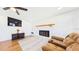 Comfortable living room showcasing a fireplace, wall-mounted television, and wood flooring at 2526 Victory Palm Dr, Edgewater, FL 32141