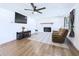Bright living room with modern features including a fireplace, ceiling fan, and a comfortable recliner at 2526 Victory Palm Dr, Edgewater, FL 32141