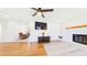 Bright living room features wood flooring, a ceiling fan, and a decorative fireplace at 2526 Victory Palm Dr, Edgewater, FL 32141