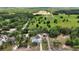 Panoramic aerial of property featuring a pool, outbuildings, long driveway, situated on a large lot at 25305 Mardon Cir, Paisley, FL 32767