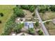 Lush aerial view of property featuring a pool, outbuildings and green trees, situated on a large lot at 25305 Mardon Cir, Paisley, FL 32767