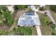 Aerial view showing pool, home with solar panels, and outbuildings; beautiful property surrounded by trees at 25305 Mardon Cir, Paisley, FL 32767