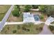 Aerial view of the house with a pool and outbuildings, manicured landscaping, and long driveway at 25305 Mardon Cir, Paisley, FL 32767