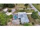 Aerial view of house, pool, and outbuildings on large lot, surrounded by lush trees and greenery at 25305 Mardon Cir, Paisley, FL 32767