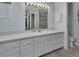 Bright bathroom featuring a long white vanity with a mirror and a separate toilet at 25305 Mardon Cir, Paisley, FL 32767